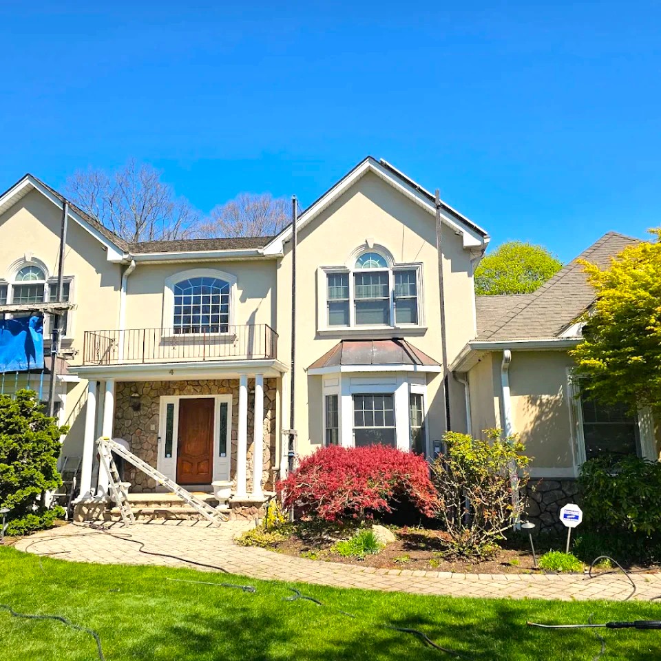 Workers repairing stucco of Pompton Lakes house